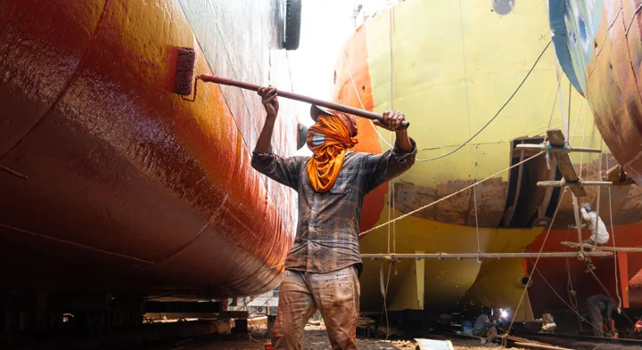 Application of a protective marine coating to a ship’s hull at a shipyard