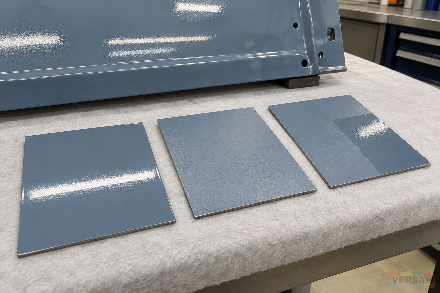 Small trial plates with different surface preparations beside a coated metal panel